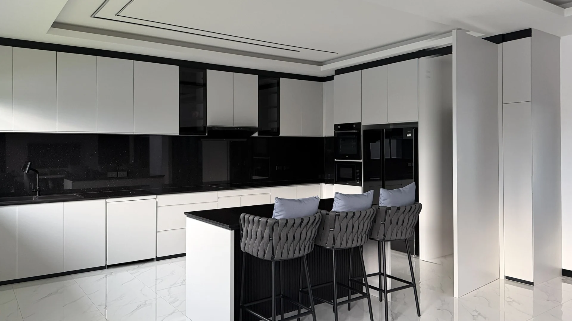 The same view by day with the hidden door open next to the fridge